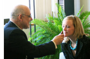 Neil Morris demonstrating a fragrance to a customer